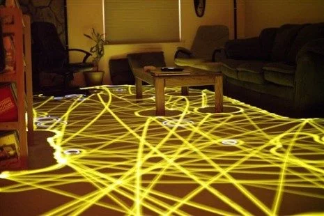 a room with a table and a coffee table showing the path of a robot vacuum
