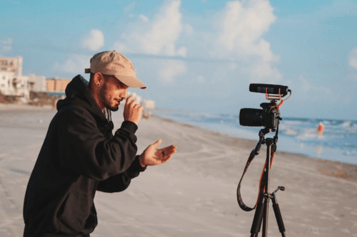 Travel Vlogger making a video on the beach