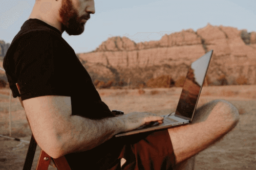 Can I Work Remotely From Another Country For A Week - Man working in desert