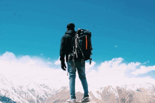 Man wearing a backpack in the mountain - Why backpacks are expensive