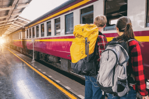 Why Are Backpacks So Expensive - Couple with backpacks at train station