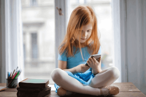 Young student learning online with a phone