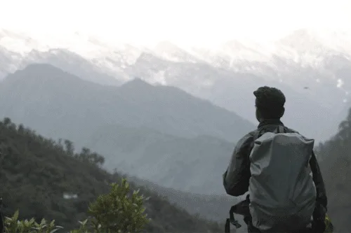 12 Best Backpacks for Traveling Asia in 2026 7 Best Backpacks for Traveling Around Asia - Man on a mountain
